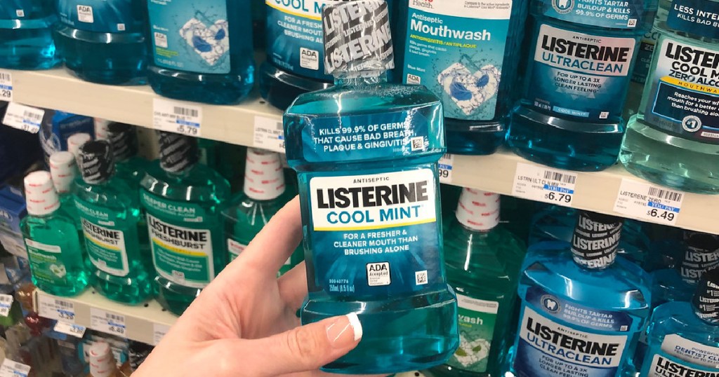hand holding bottle of mouthwash in store