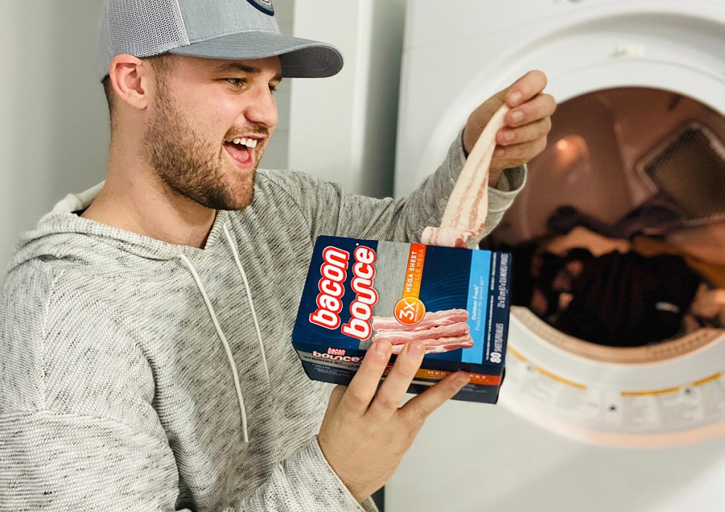man holding bacon bounce by dryer