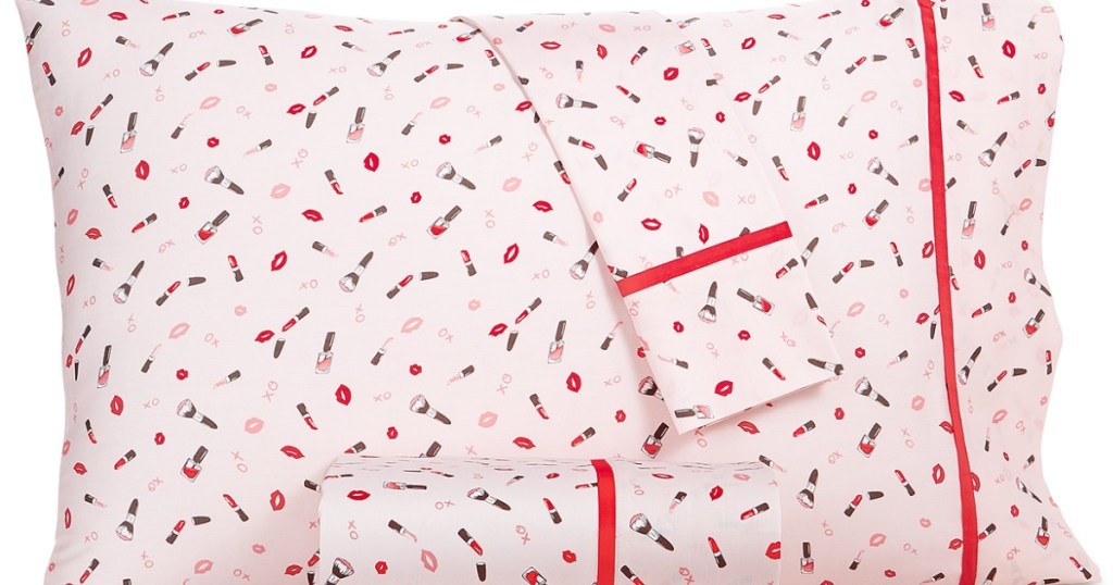 pillow and sheets with pink designs on them