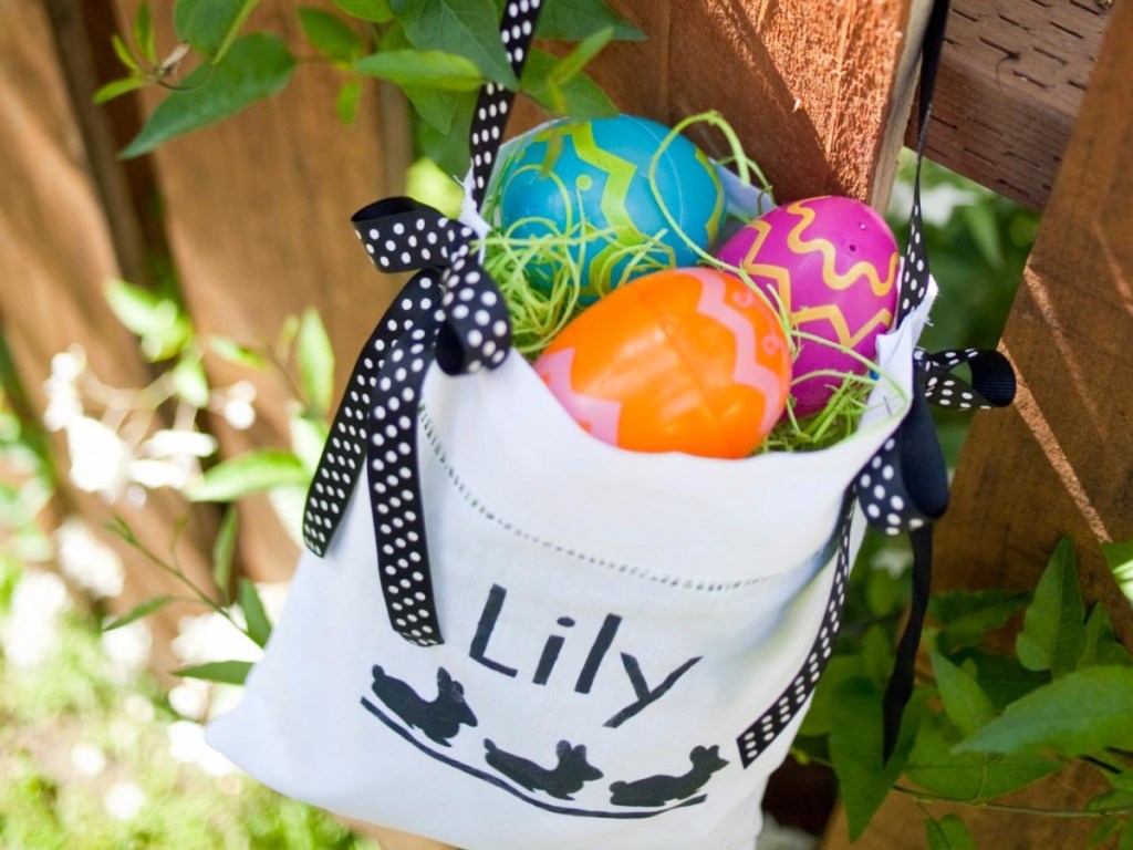 tote bag stenciled with the name Lily filled with Easter eggs