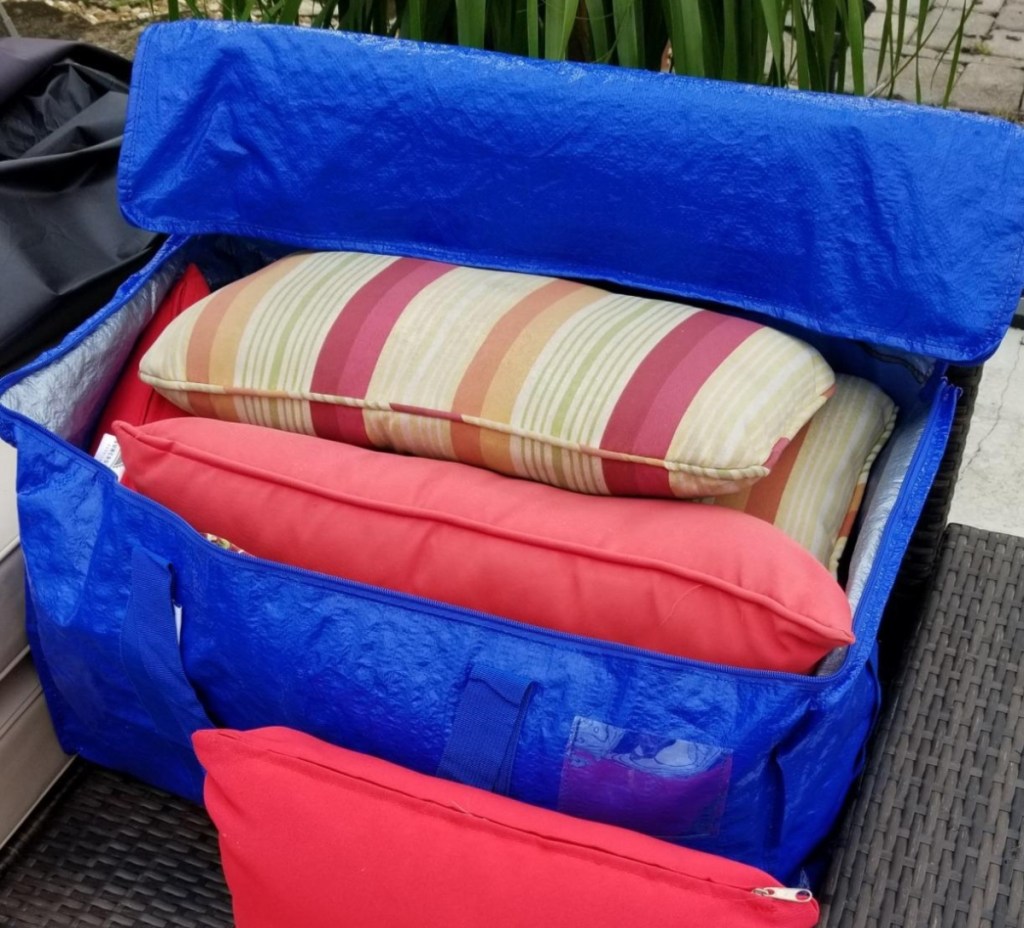 blue storage bag with patio cushions inside