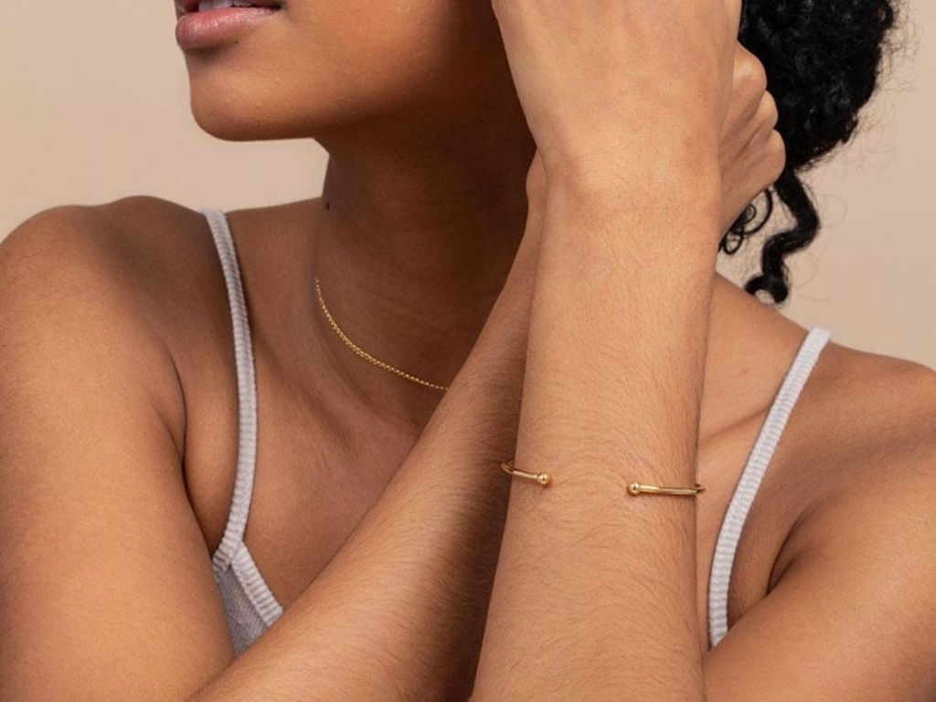 woman wearing gold cuff bracelet