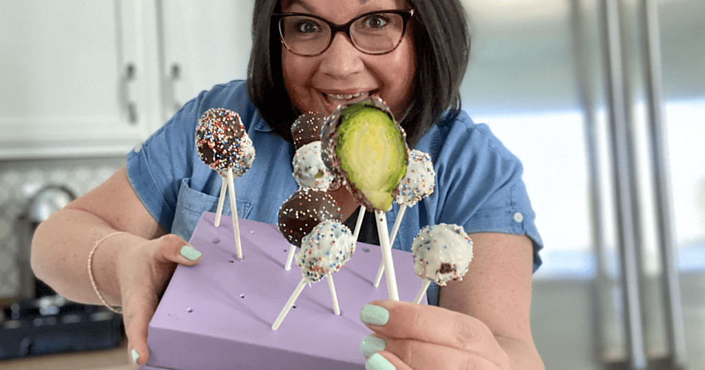 woman holding Brussels sprouts cake pops