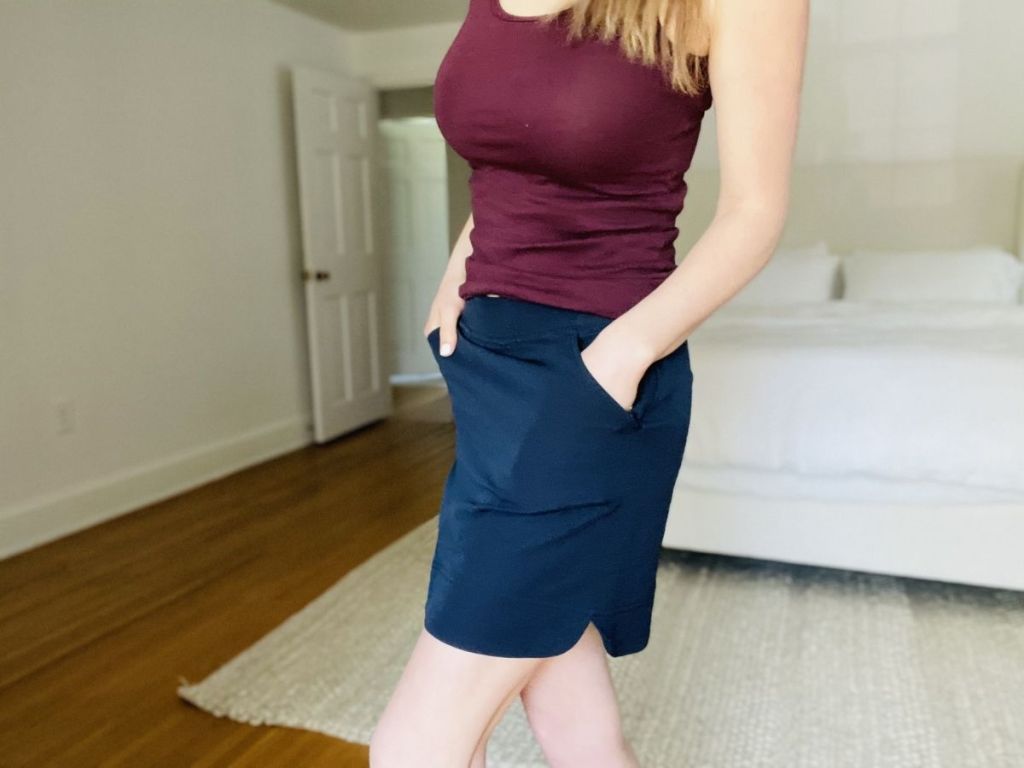 woman wearing burgundy tank and blue skorts