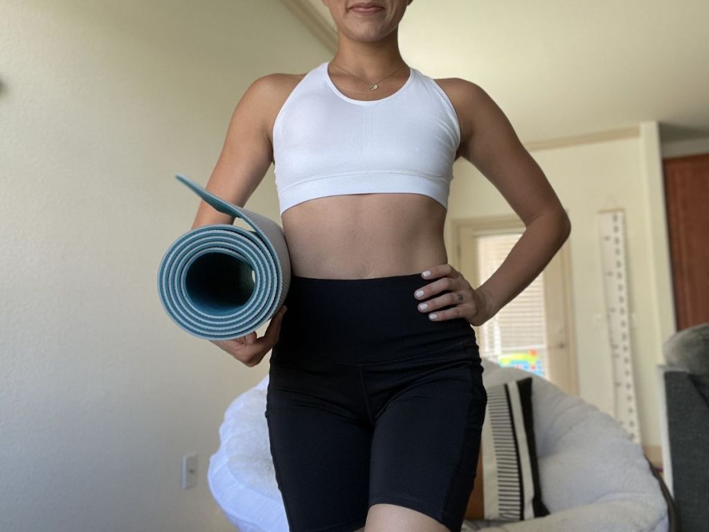 woman holding yoga mat