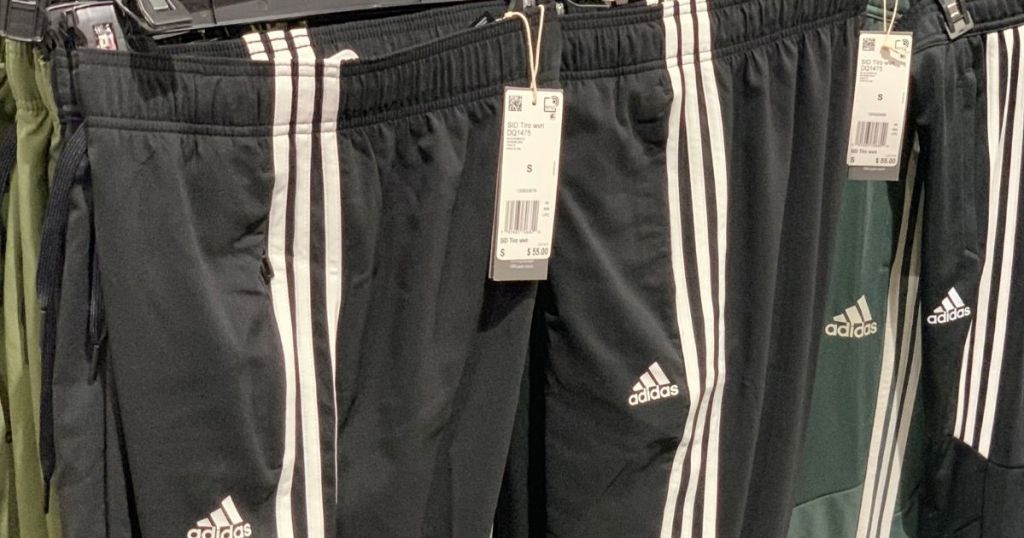 row of adidas pants on hangers