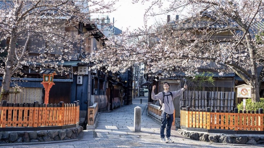 man giving a tour of Japanese neighborhood