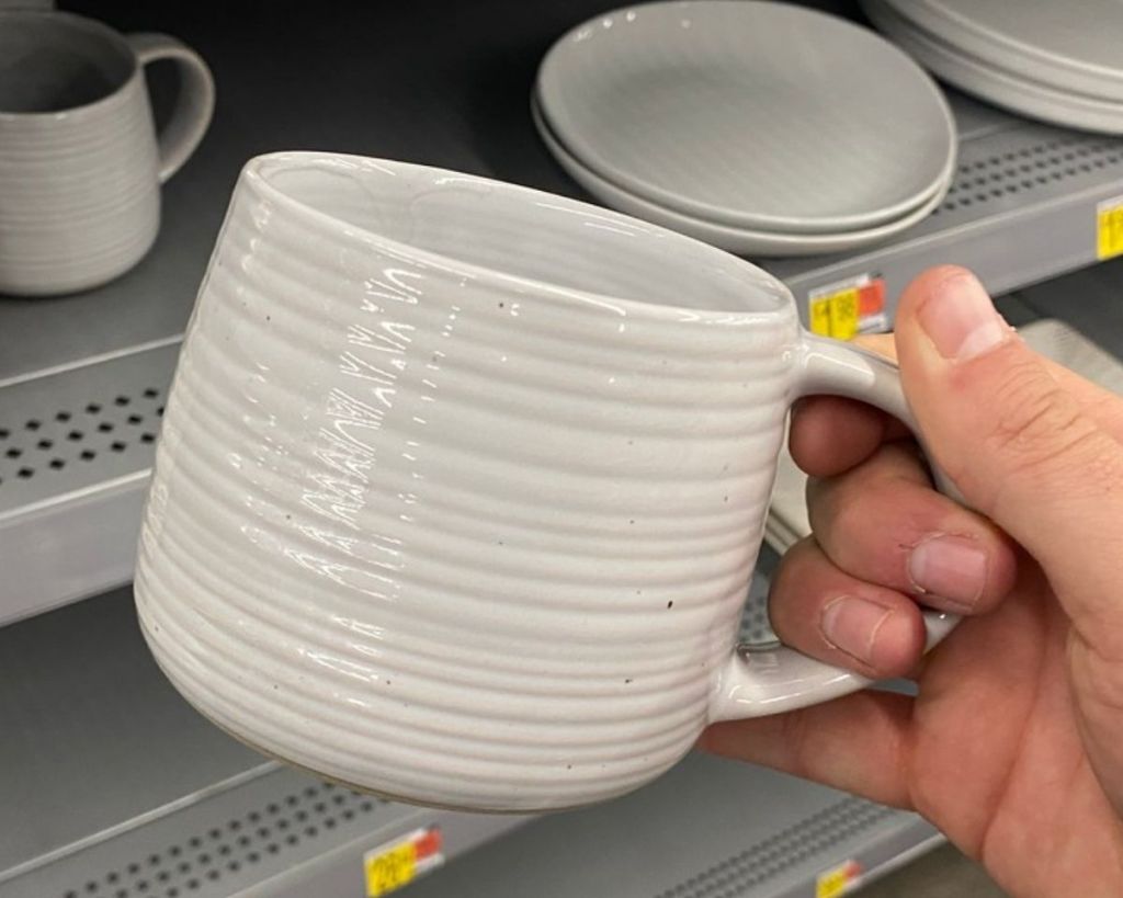 hand holding Better Homes & Gardens Clay Mug in-store