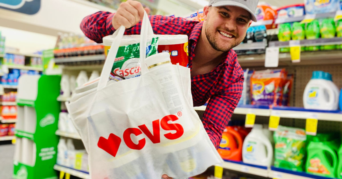 Man holding CVS reusable bag inside store filled with products