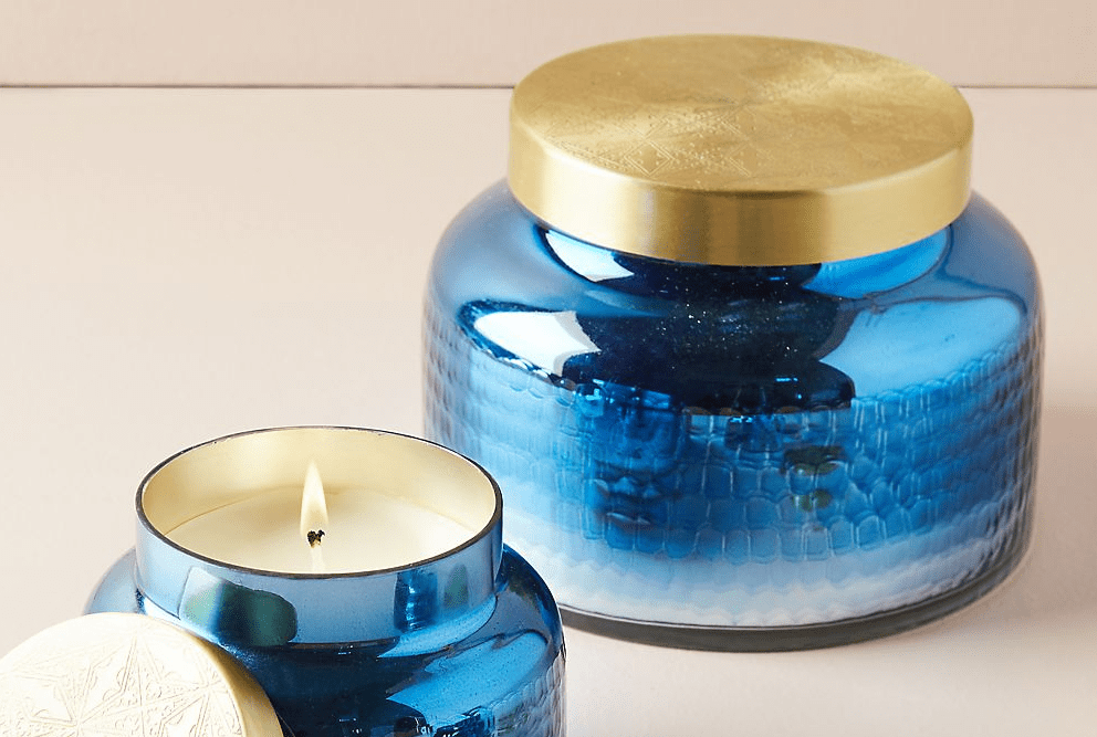two candles with blue jars