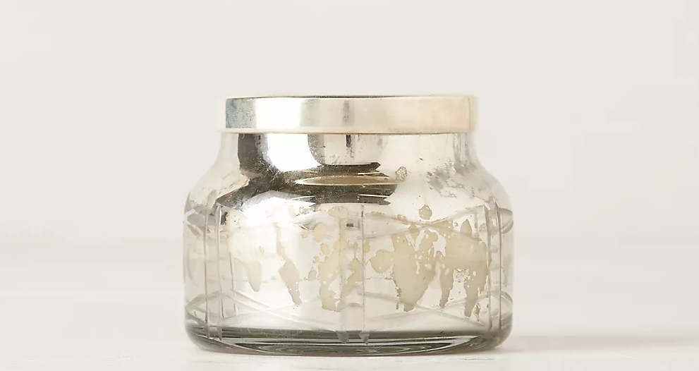 candle in a silver jar