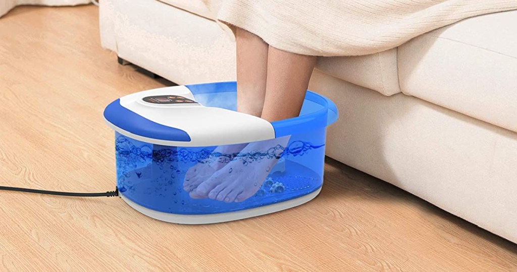 woman soaking feet in blue foot spa