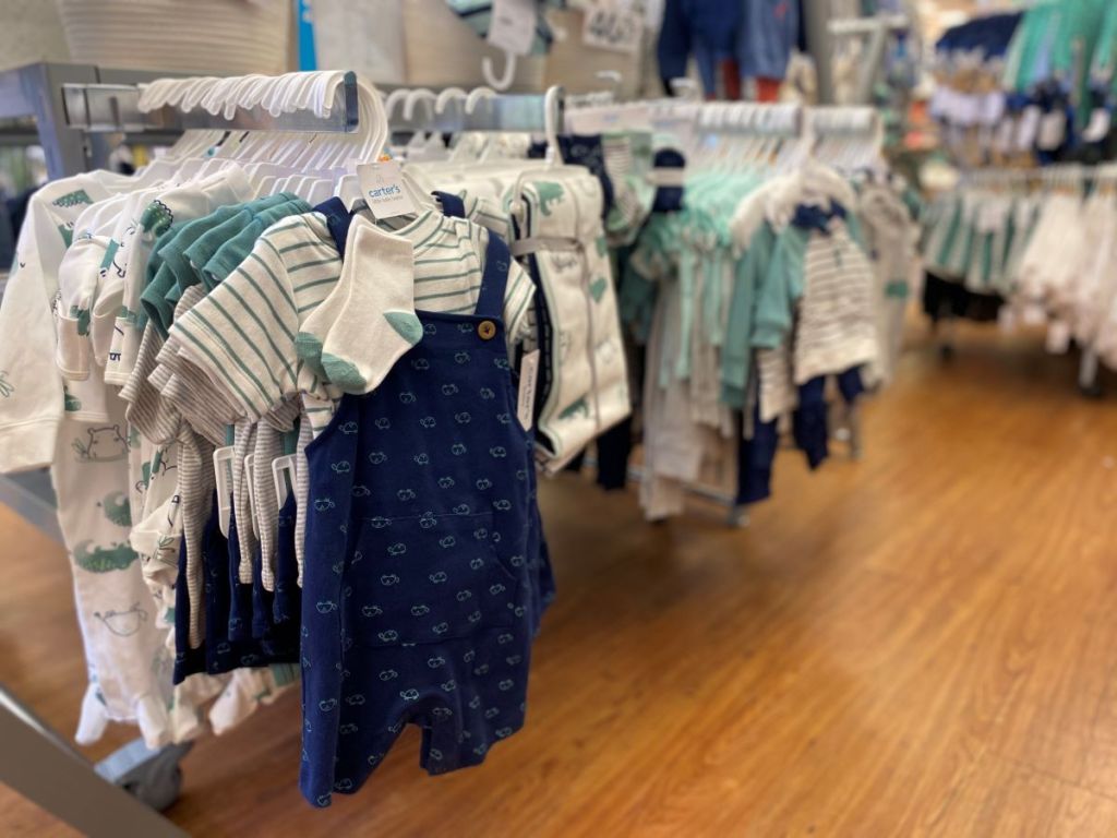 baby outfits on hangers at Carter's