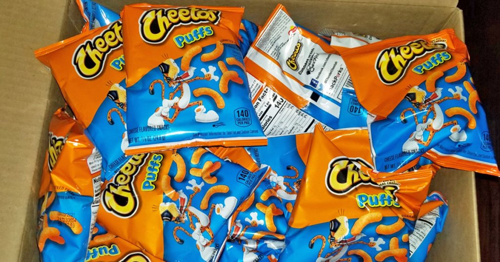 orange and blue bags of cheetos puffs in a cardboard box