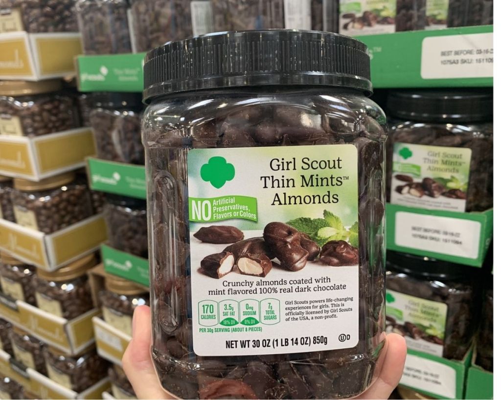 hand holding Costco Girl Scouts Thin Mints Almonds in store