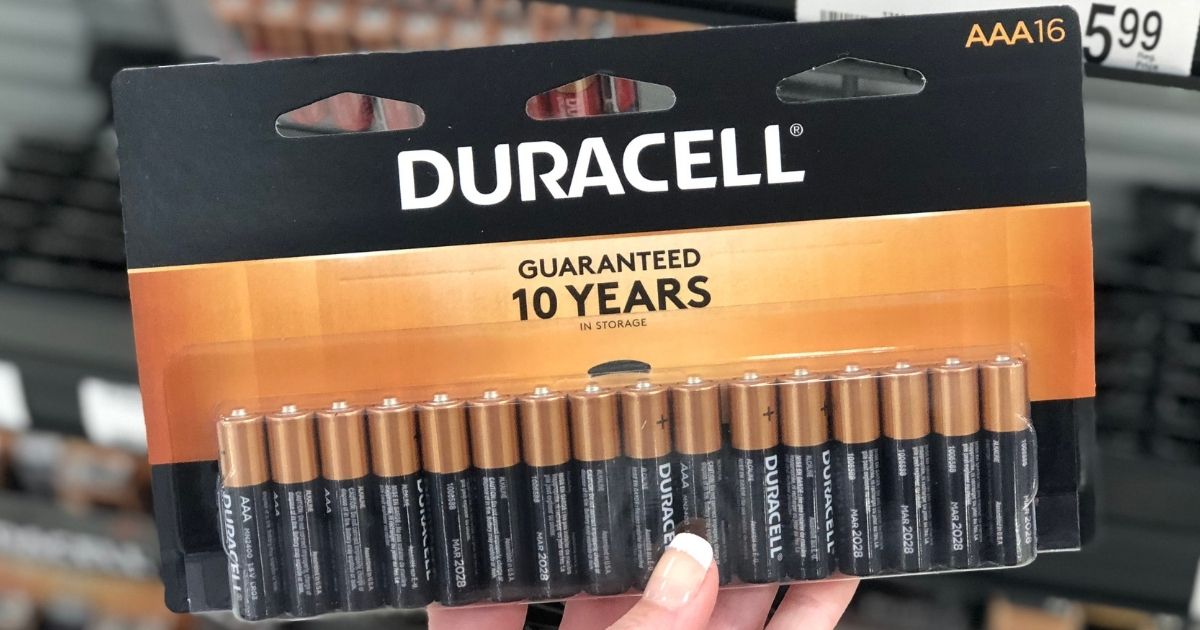 hand holding a package of Duracell batteries