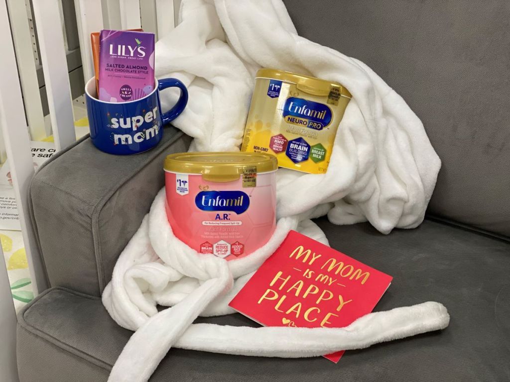 infant formula on a chair with a robe, mug and card