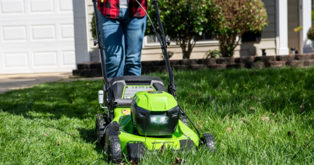 person pushing a greenworks cordless lawn mower
