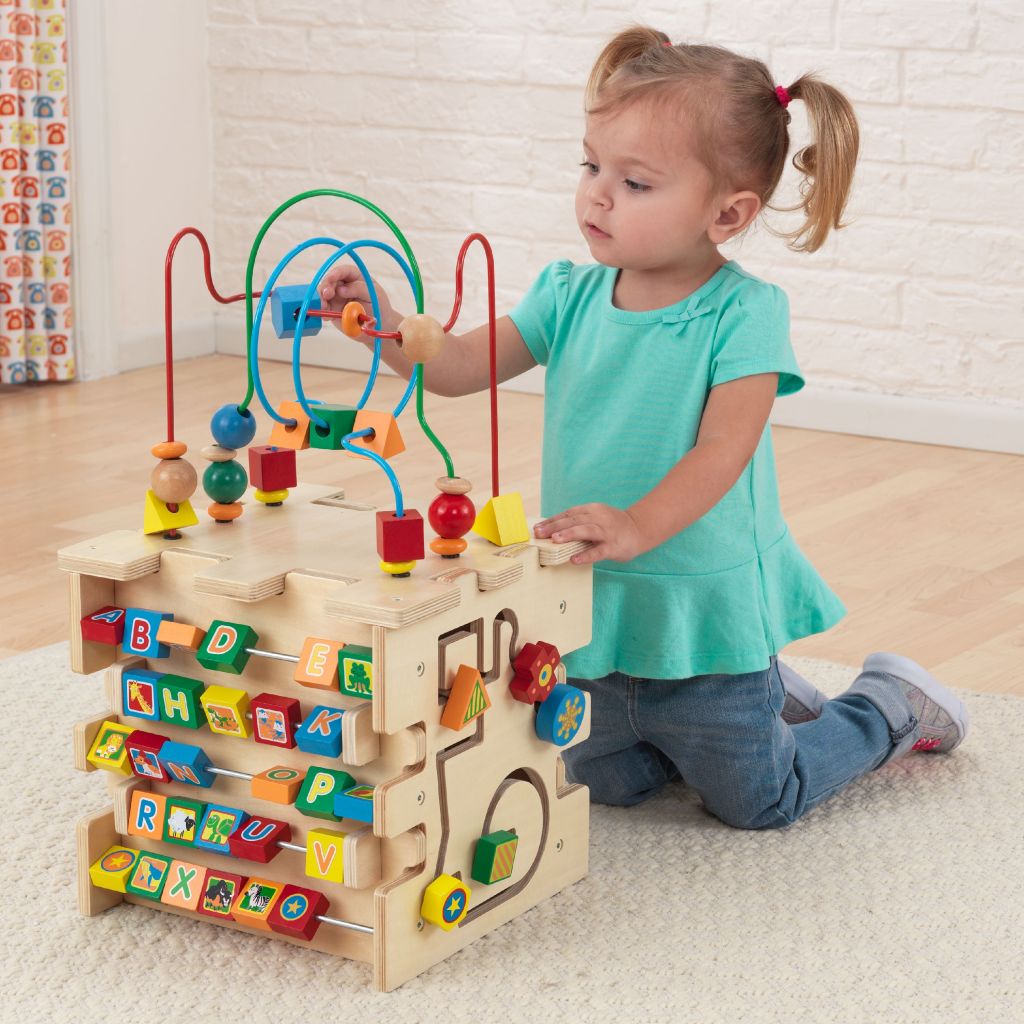 Little girl playing with KidKraft Cube