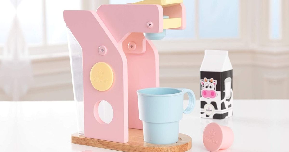 Kidkraft Pastel Coffee Maker and accessories set up on table in front of window