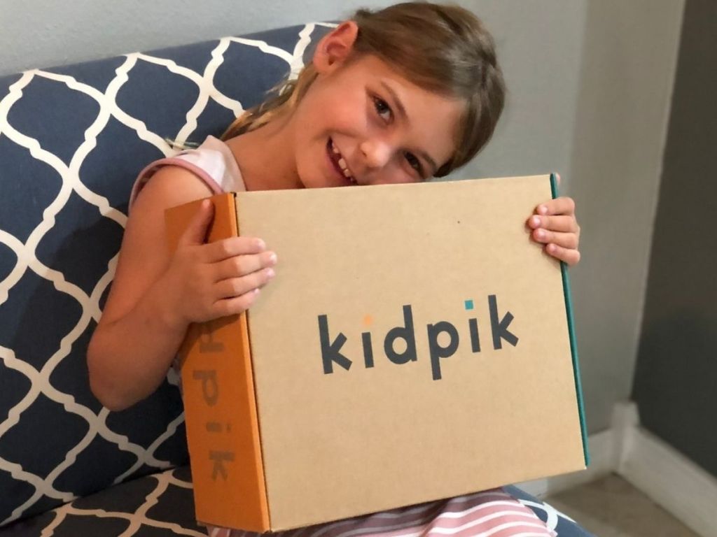 Little girl holding a KipPik Clothing BOx