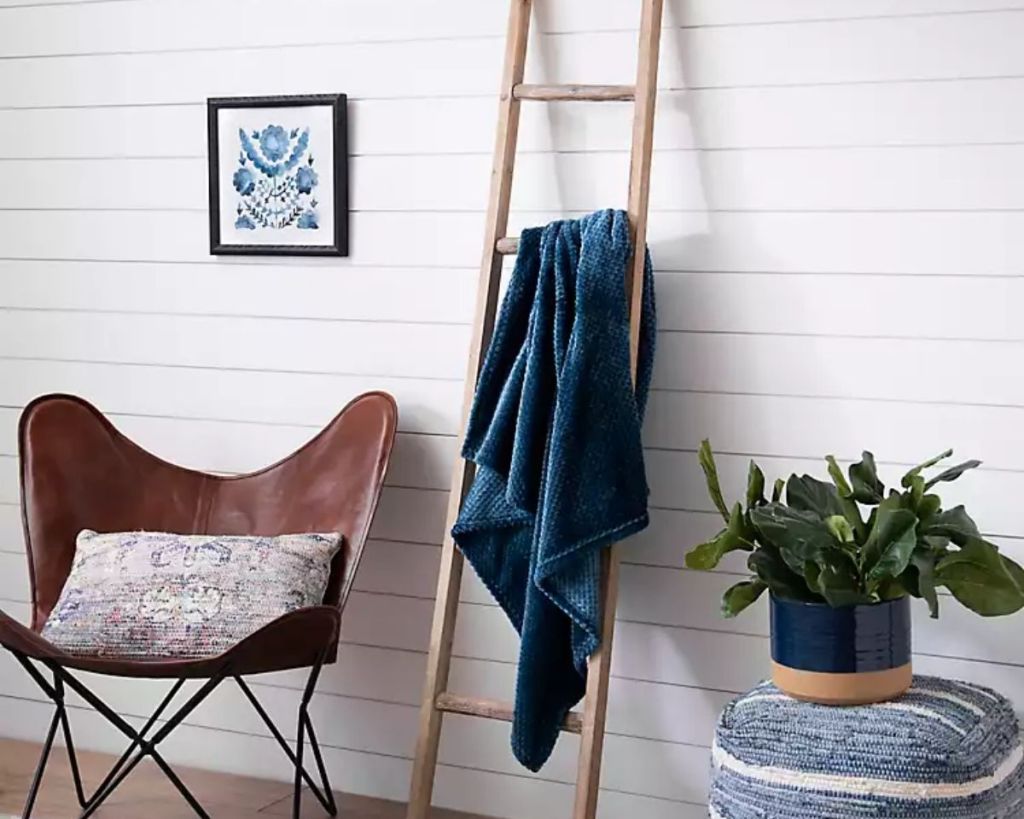 Kirkland's Blanket Ladder with navy blanket in room setting