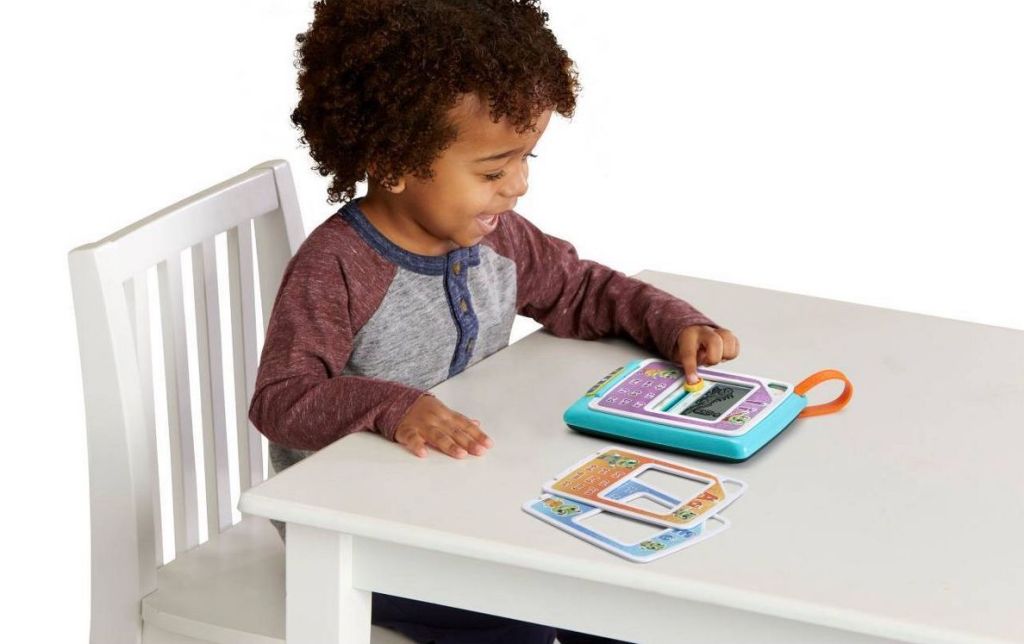 kid playing LeapFrog Phonics game in table