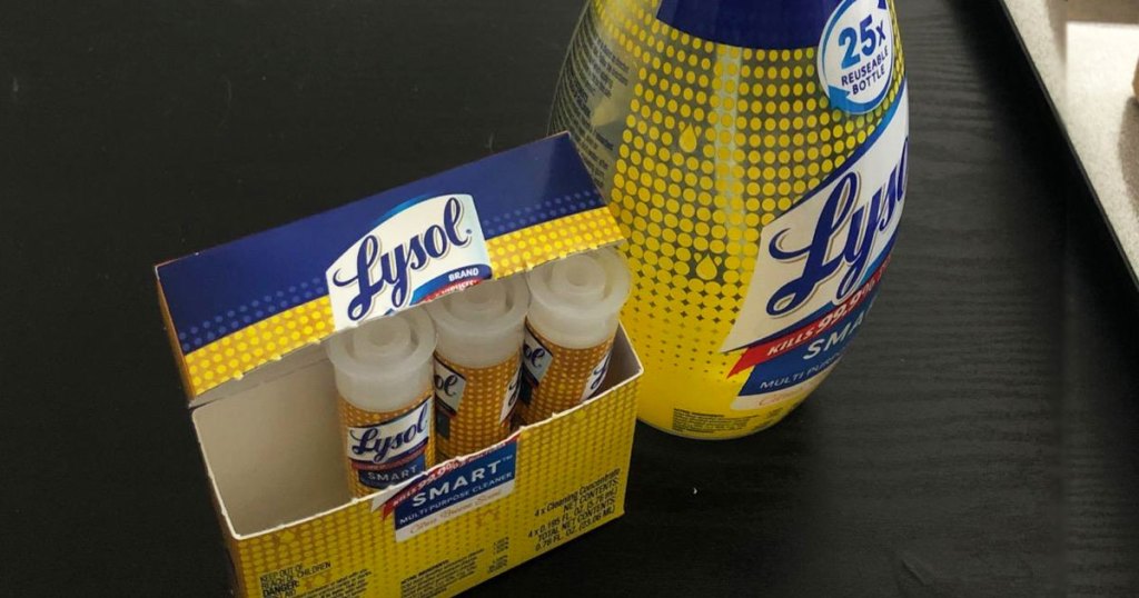 Lysol reusable bottle and box of refill cartridges on black table