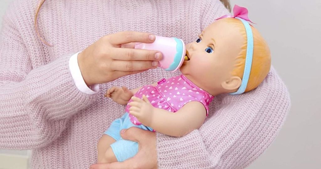 child feeding bottle to Mealtime Magic Mia Baby Doll