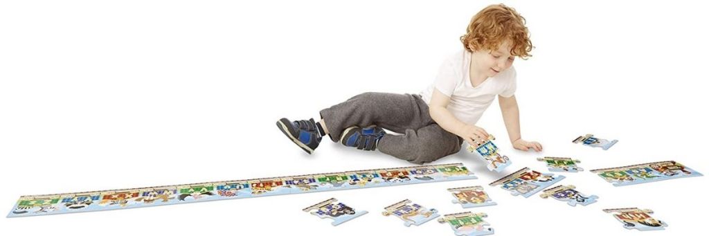 child playing with Melissa & Doug Alphabet Train Puzzle