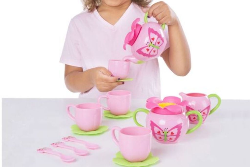 child pouring from Melissa & Doug Bella Butterfly Tea Set