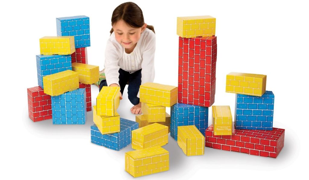 girl playing with cardboard blocks