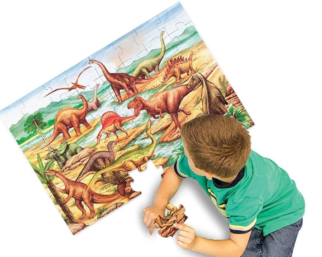 child playing with Melissa & Doug Dinosaurs Floor Puzzle
