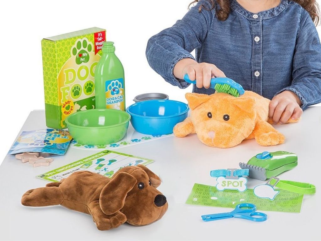 kid playing with pet care set