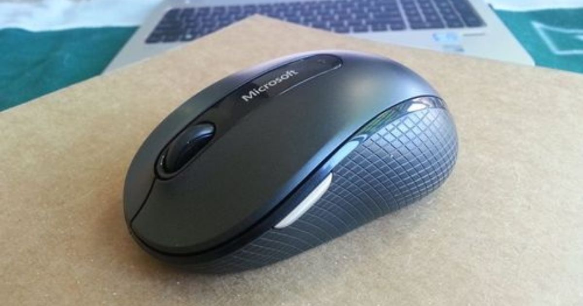 Microsoft Wireless Mouse near laptop