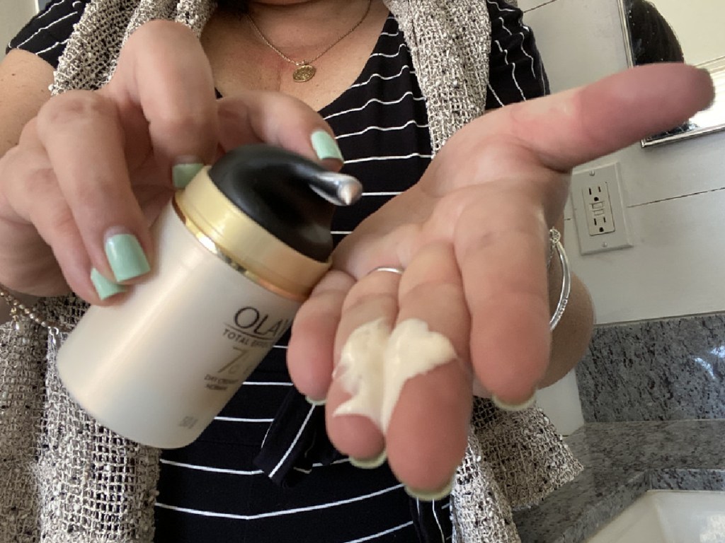 lady holding olay moisturizer 