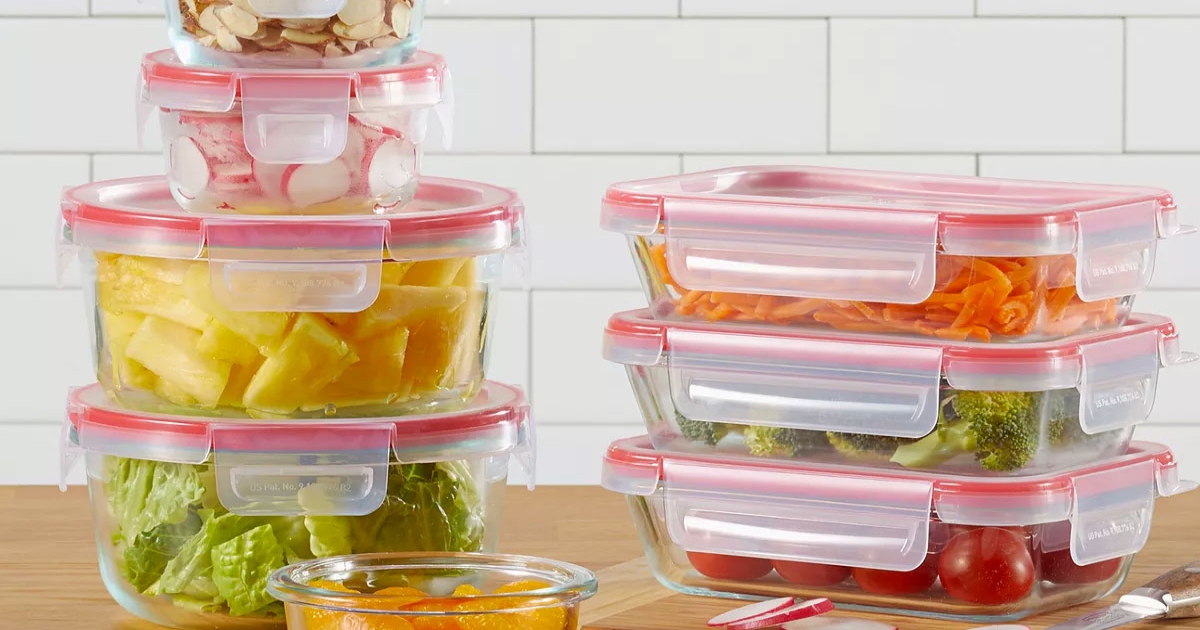 pyrex food storage set on a counter with lids, filled with food items.