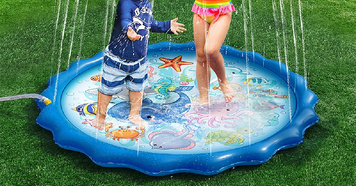 one boy and one girl in bathing suits standing on a sprinkler water mat
