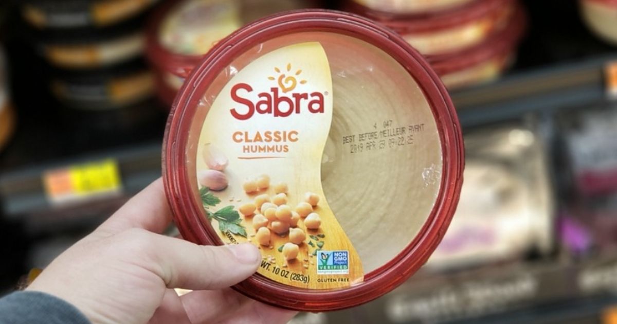 hand holding Sabra 10oz Classic Hummus