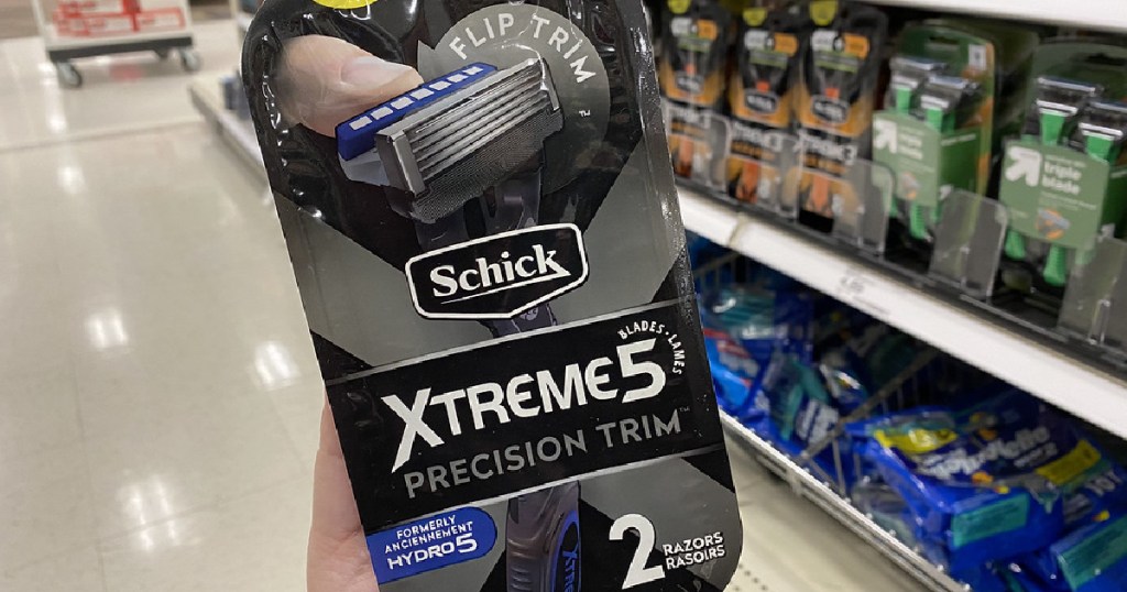 hand holding pack of men's disposable razors in store