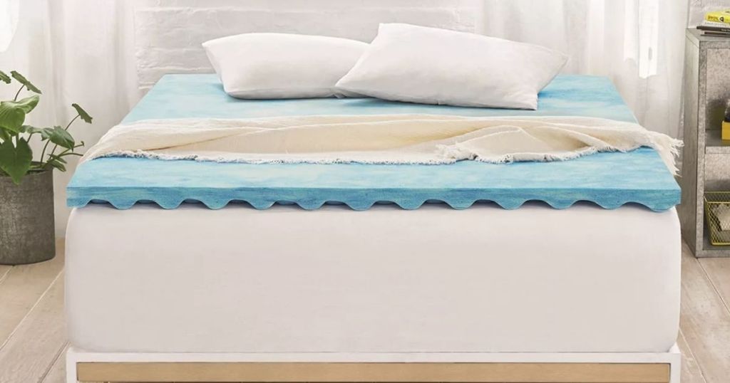 bed with a mattress topper on it