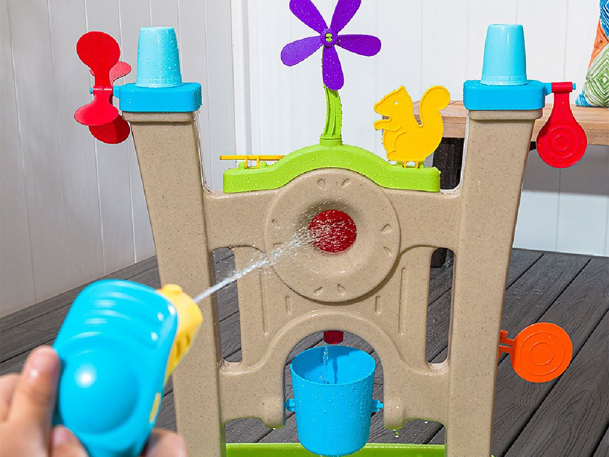 sprayer using water to hit a target on a kids water wall toy