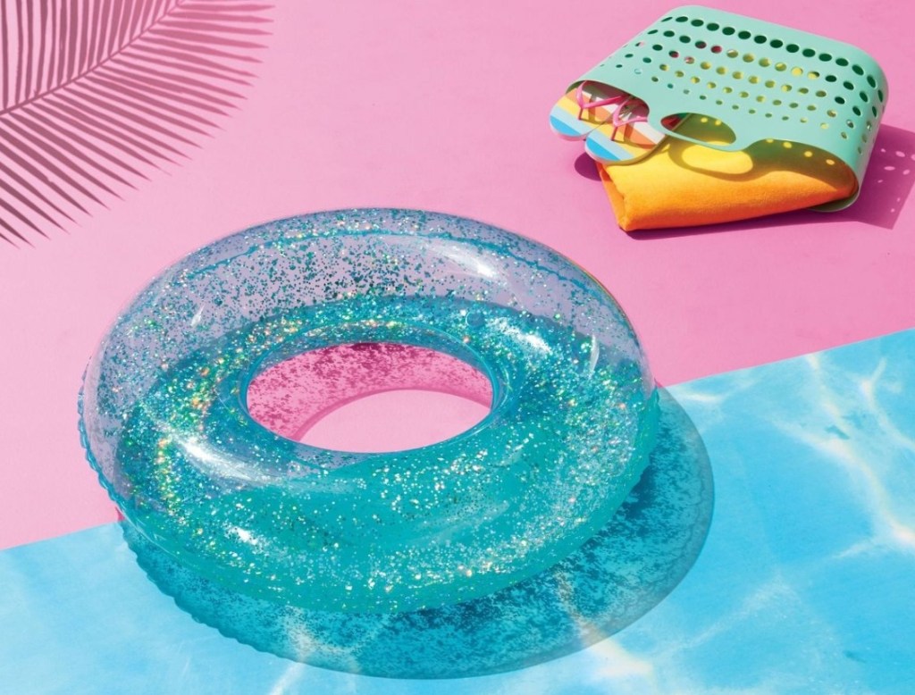 Sun Squad Glitter Float next to a beach bag