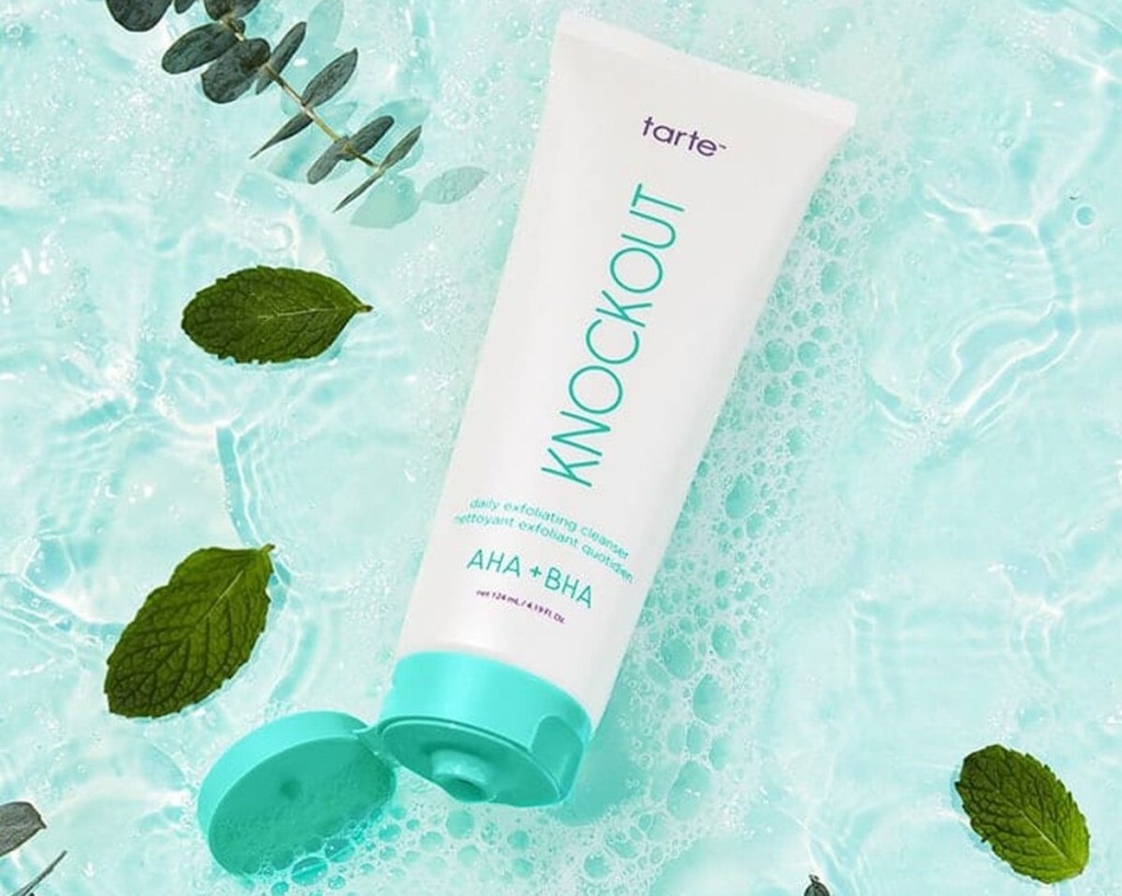 Tarte Knockout Cleanser surrounded by water and leaves