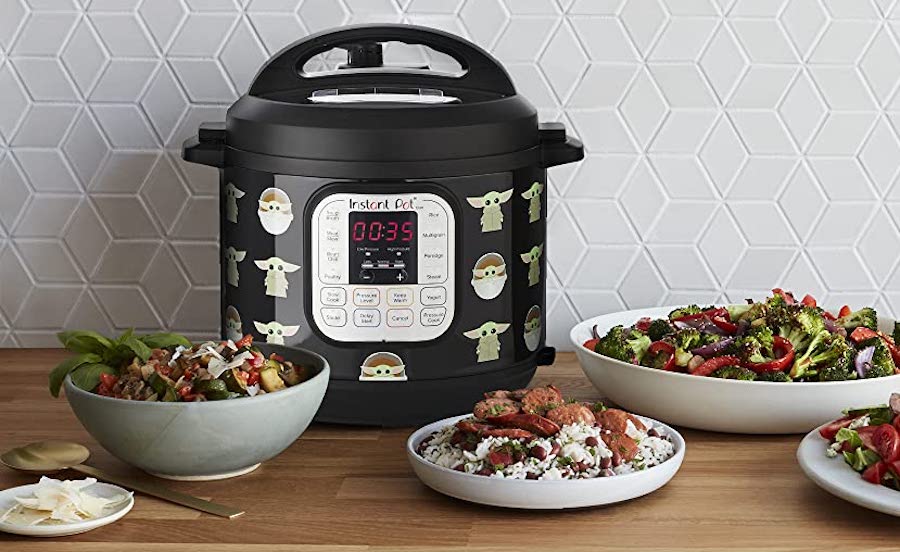 The Child Instant Pot next to plates of cooked dishes