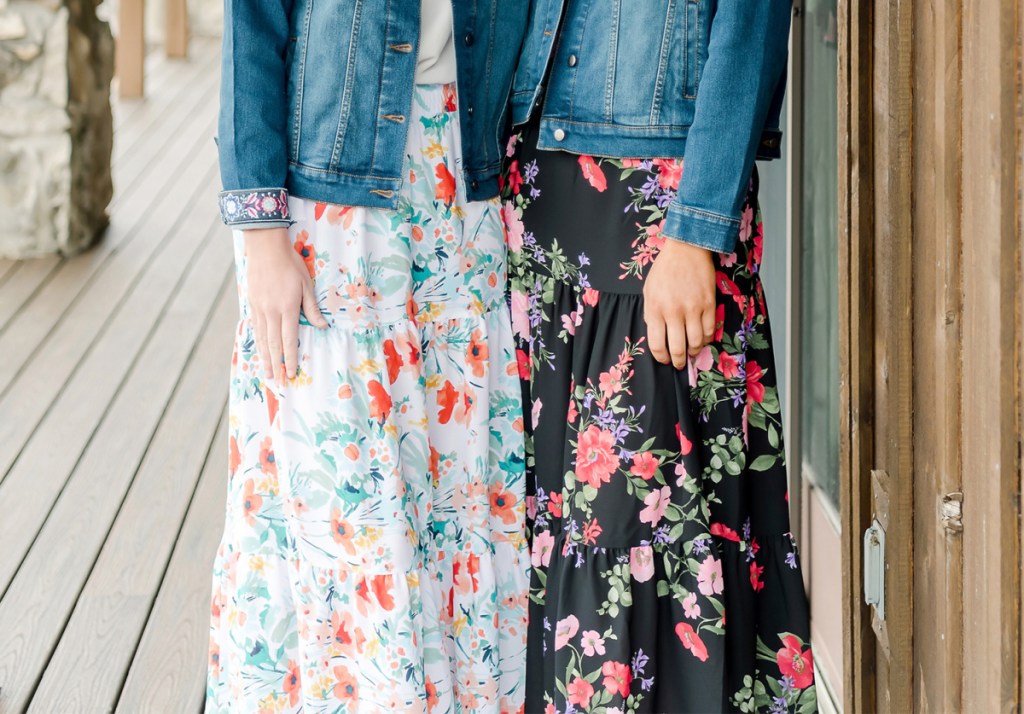 two women wearing floral skirts