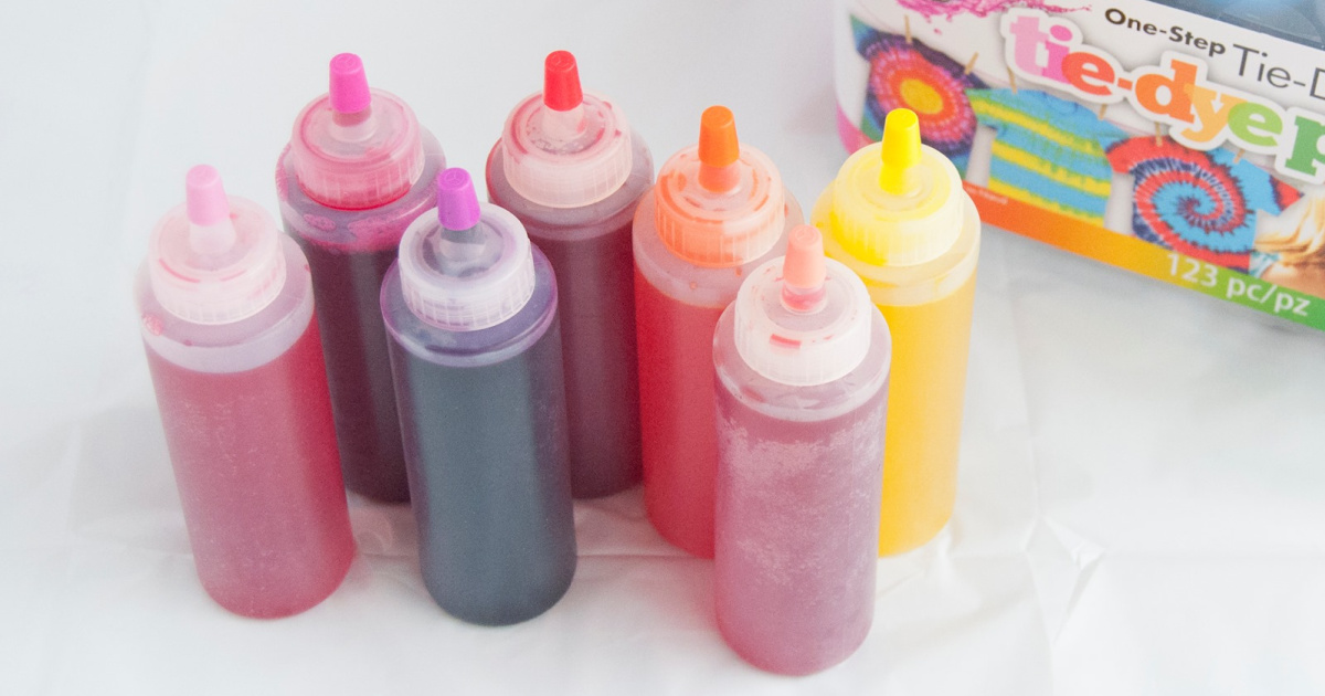 seven plastic bottles filled with tie-dye colors