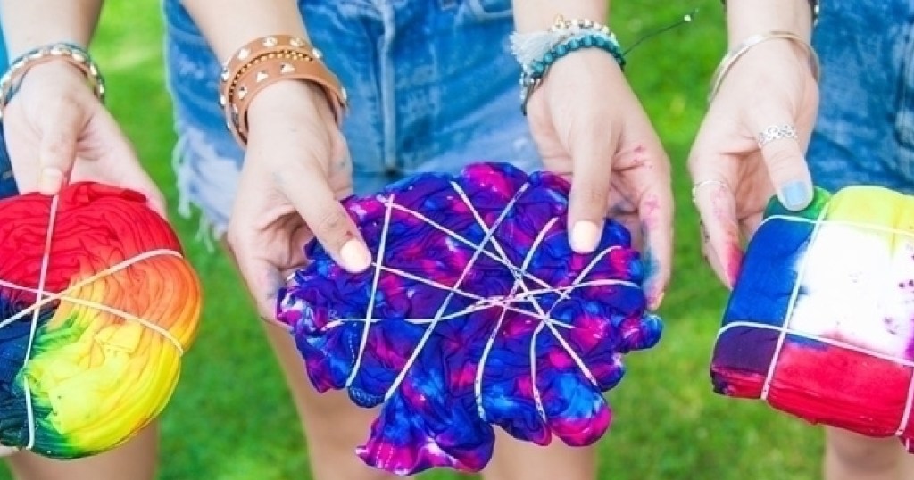 Girls holding Tie Dye Shirts