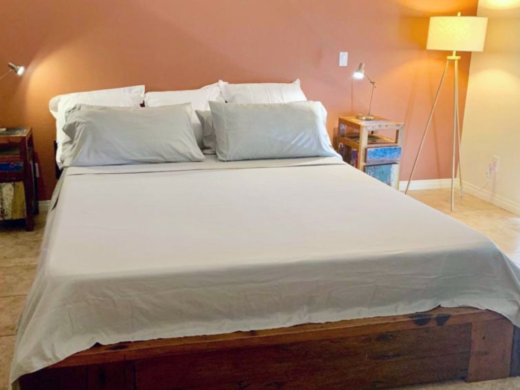 pale green sheets on king-size bed