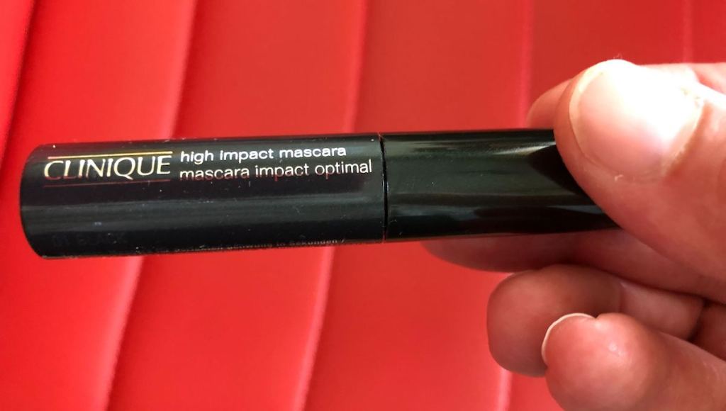 hand holding tube of clinique high impact mascara
